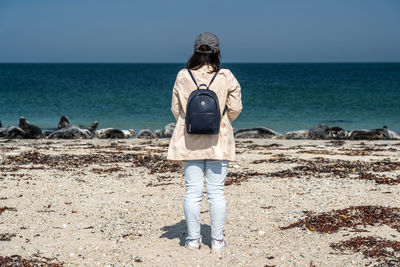 Rear view of man standing on beach