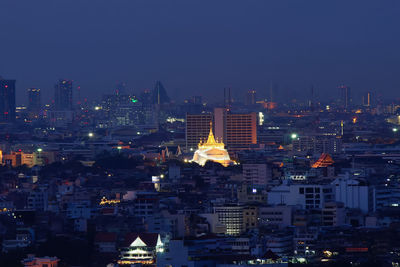 Aerial view of illuminated buildings in city at night