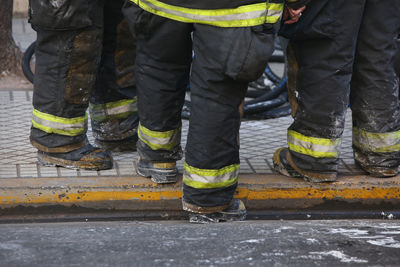 Low section of firefighters on footpath