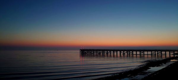 Scenic view of sea against clear sky during sunset