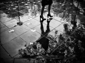 Low section of woman standing on tiled floor