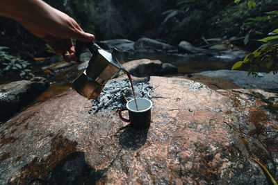 Midsection of person holding ice cream rock