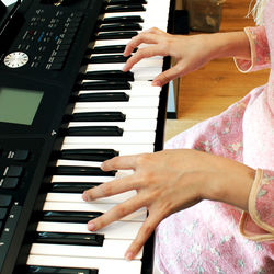 Close-up of hands playing piano