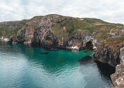 Scenic view of sea and mountains against sky