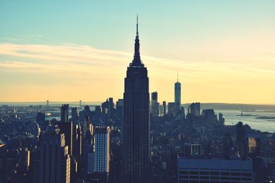 Skyscrapers in city at sunset