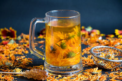 Close-up of flowers in cup on table