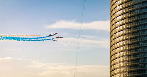 Low angle view of airplane flying against sky