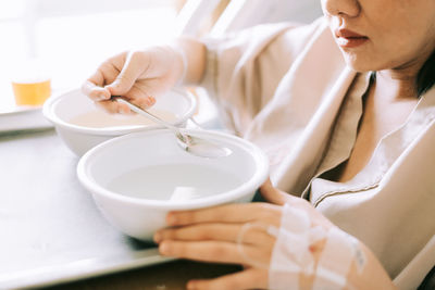 Midsection of woman holding ice cream