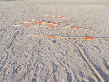 High angle view of sticks on sand