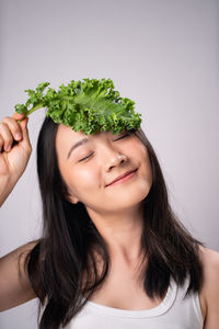 Portrait of woman against white background