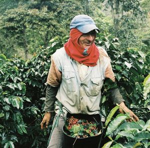 Midsection of man standing by plants