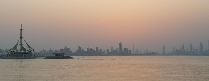 View of buildings in city at sunset