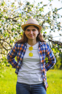 Girl in garden. defocus beautiful young woman near blooming spring tree. white blooming trees. youth