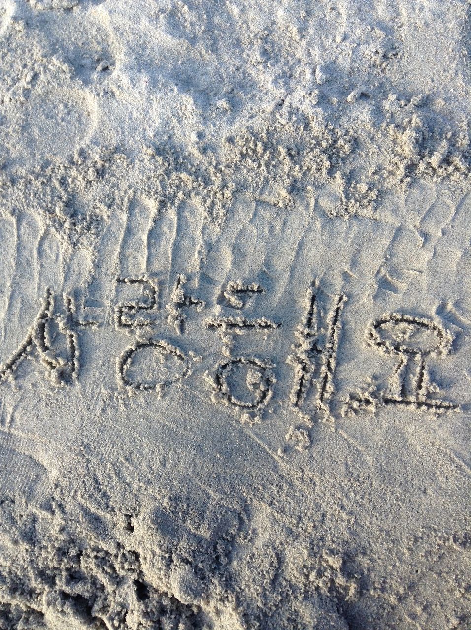 high angle view, text, full frame, communication, footprint, western script, textured, backgrounds, water, day, sand, close-up, no people, outdoors, beach, wet, pattern, nature, asphalt, street