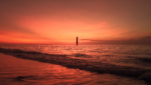 Scenic view of sea against orange sky