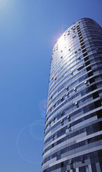 Low angle view of modern building against clear blue sky