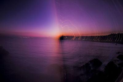 Scenic view of sea against sky at night