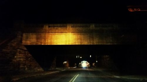 Illuminated tunnel at night