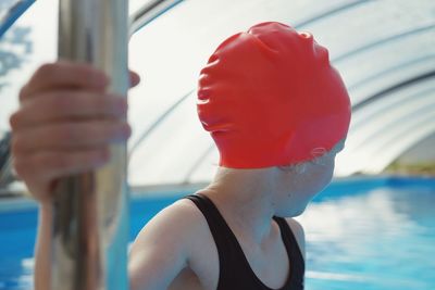 Close-up of girl wearing red swimming cap