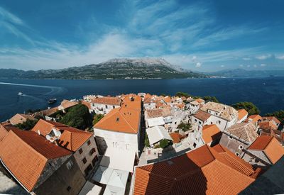 Town by sea against sky