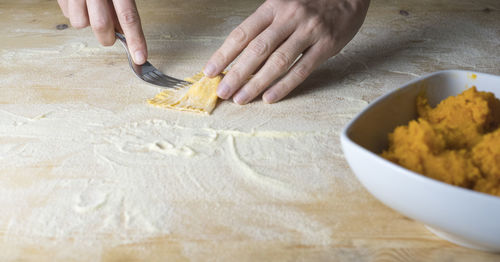 Cropped image of woman preparing food on table