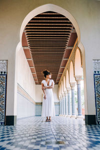 Woman standing on a corridor of a temple