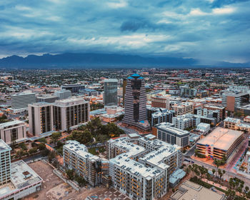 Drone view of downtown tucson, arizona at dusk. monsoon rain in the distance.