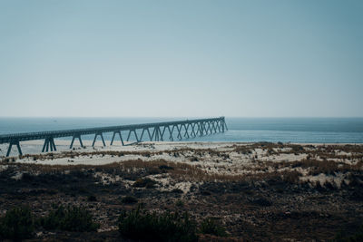 Scenic view of pier in the sea against clear sky