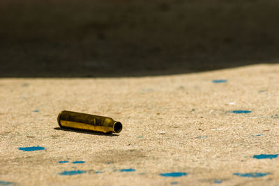 Close-up of cigarette on sand