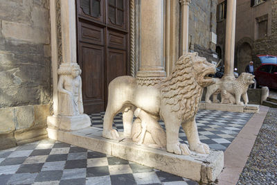 Marble lions at the entrance to santa maria maggiore, in the ancient city of bergamo, italy