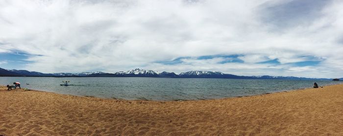 Panoramic view of beach against cloudy sky