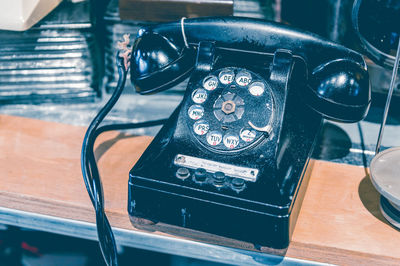 High angle view of old telephone on table