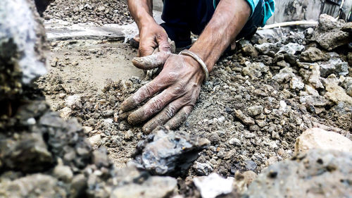 Low section of person working in mud