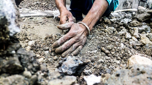 Low section of man working on messy field