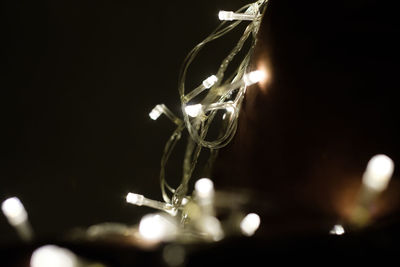 Close-up of illuminated lights against black background