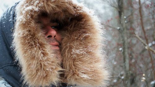 Close-up of man wearing fur coat during winter