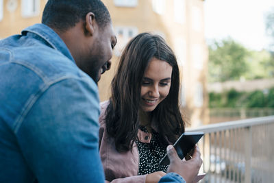 Young man using smart phone outdoors