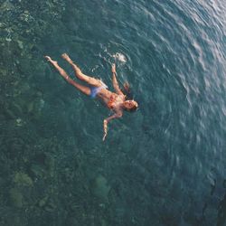 High angle view of man swimming in sea