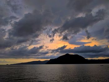 Scenic view of dramatic sky over sea during sunset