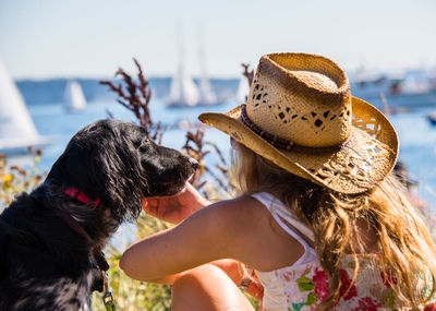 Midsection of woman with dog in water