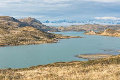 Scenic view of lake and mountains against sky