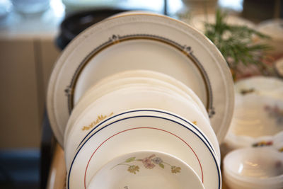 Close-up of white plates on table at home