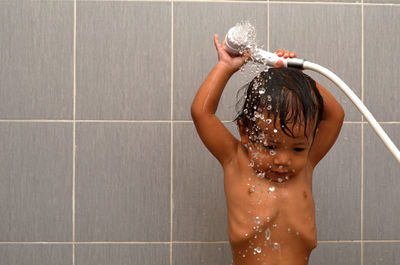 Cute shirtless girl bathing in bathroom