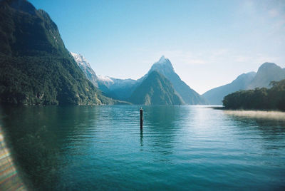 Scenic view of lake and mountains against clear sky