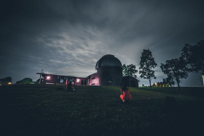 Built structure on field against sky