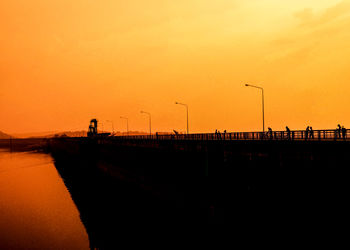 Silhouette bridge against sky during sunset