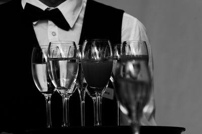 Midsection of waiter serving drinks