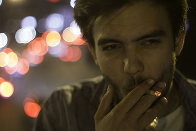 Close-up portrait of man smoking