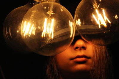 Close-up portrait of young woman with reflection in mirror