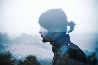 Double exposure of man and mountain